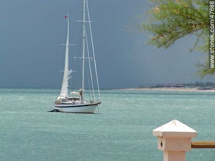 Sailboat in a turquoise sea and approaching storm - Department of Maldonado - URUGUAY. Photo #47688