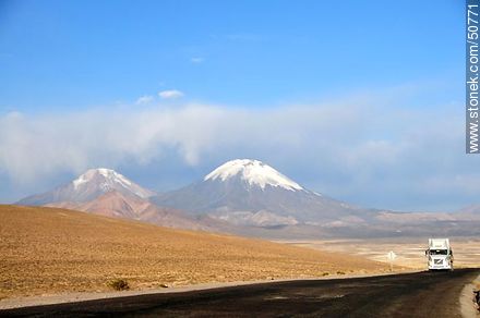 Truck on Route 11 from Bolivia. Pomerape and Parinacota volcanoes in the mountains of Nevados de Payachatas - Chile - Others in SOUTH AMERICA. Photo #50771