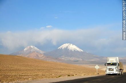 Truck on Route 11 from Bolivia. Pomerape and Parinacota volcanoes in the mountains of Nevados de Payachatas - Chile - Others in SOUTH AMERICA. Photo #50767