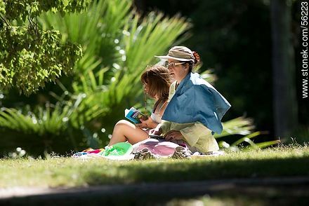 Mother and daughter in the park sunbathing - Department of Montevideo - URUGUAY. Photo #56223