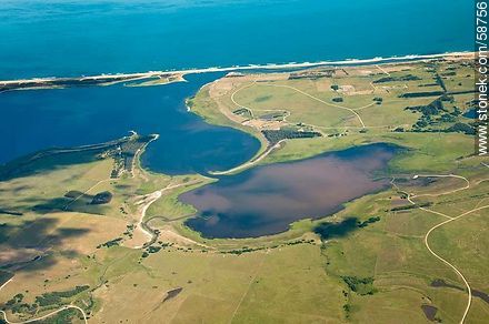 Aerial view of the Laguna Garzón and the thin line of beach coastline that separates the Atlantic Ocean - Punta del Este and its near resorts - URUGUAY. Photo #58756