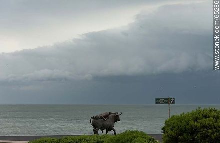 Sculpture of a bull and a woman in approaching storm - Punta del Este and its near resorts - URUGUAY. Photo #65286