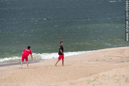 Lifeguards having fun in a stormy day and empty beach - Department of Maldonado - URUGUAY. Photo #65986