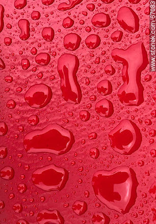 Water drops on a bright red background -  - MORE IMAGES. Photo #67083