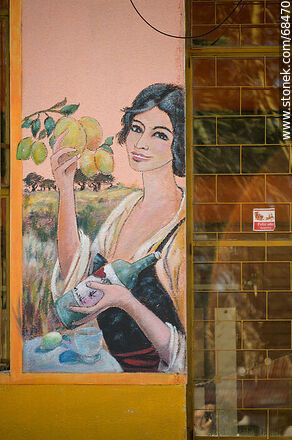 Mural of a woman with a bottle in her hand - Department of Florida - URUGUAY. Photo #68470