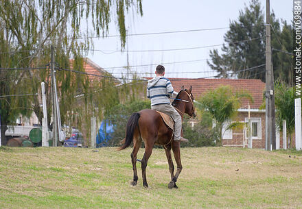 Rider on horseback near route 5 - Department of Canelones - URUGUAY. Photo #69884
