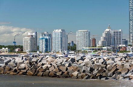 Blocks of the harbor breakwater with buildings on Williman Creek in the background. - Punta del Este and its near resorts - URUGUAY. Photo #71856
