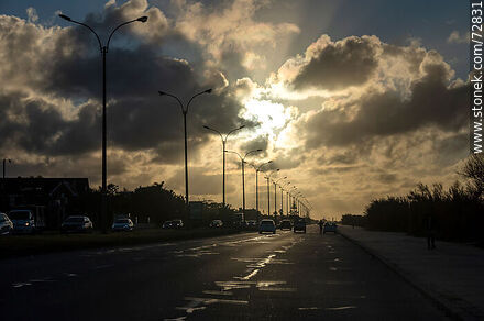 The sun through the clouds in a winter sunrise on the promenade - Department of Montevideo - URUGUAY. Photo #72831