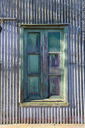 Window shutter in a corrugated sheet metal wall - Department of Cerro Largo - URUGUAY. Photo #74282