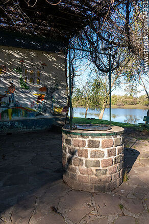 Cistern and mural in front of the river - Department of Cerro Largo - URUGUAY. Photo #74331