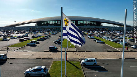 Aerial view of the Uruguayan flag flying in front of the airport parking lot - Department of Canelones - URUGUAY. Photo #78501