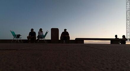 Aerial photo of silhouettes on the promenade at sunset - Department of Montevideo - URUGUAY. Photo #78847