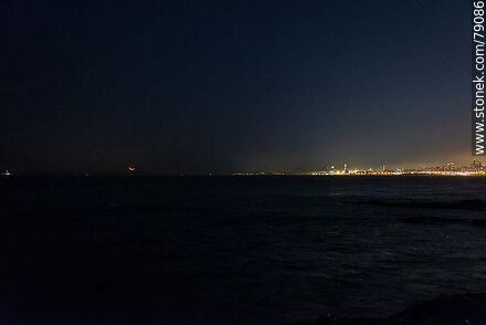 The new moon about to set in the sea in front of the port of Montevideo - Department of Montevideo - URUGUAY. Photo #79086
