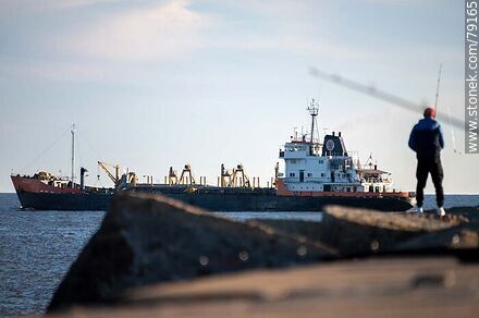 Fisherman on the Sarandí breakwater and a ship leaving the port - Department of Montevideo - URUGUAY. Photo #79165