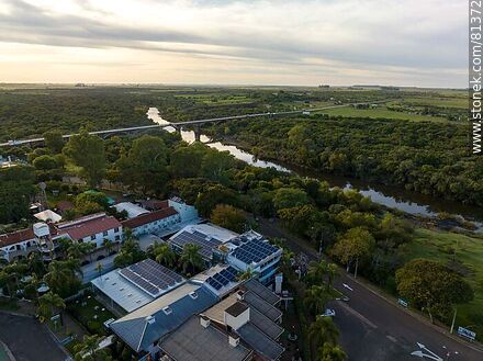 Aerial view of Termas del Daymán. Hotels and cabins. Bridge over the Daymán River. Solar panels - Department of Salto - URUGUAY. Photo #81372