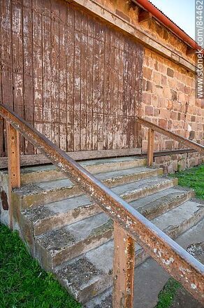 Tomás Gomensoro's Zanja Honda railroad station. Stairs to the boarded up entrance of the freight shed. - Artigas - URUGUAY. Photo #84462