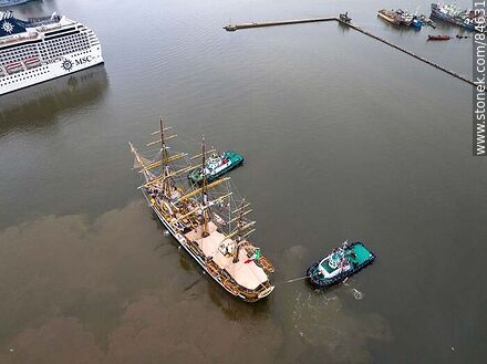 Aerial view of tugboats maneuvering with the training ship Amerigo Vespucci - Department of Montevideo - URUGUAY. Photo #84631