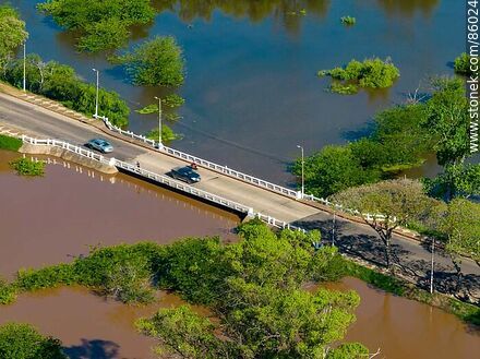 Vista aérea del puente de la rambla Tomás Berreta sobre la división del arroyo Ceibal y el río Uruguay, ambos muy crecidos - Departamento de Salto - URUGUAY. Foto No. 86024