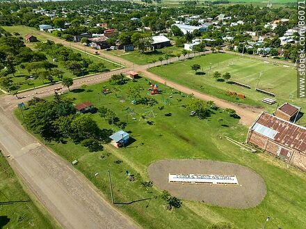 Aerial view of the Tomás Gomensoro sign next to the old railroad station - Artigas - URUGUAY. Photo #86071